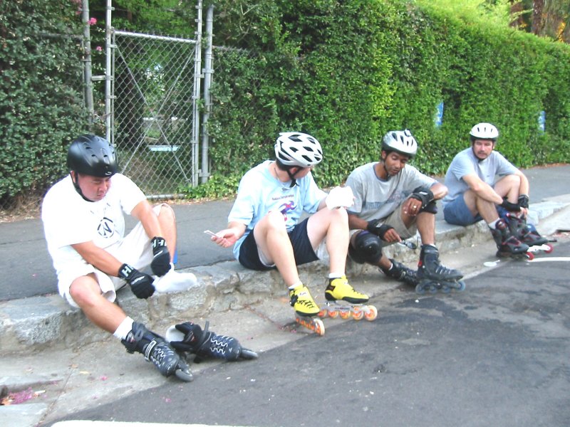 Derek prepares to put a bandaid on a blister on the July 26, 2004 Monday Night Skate.