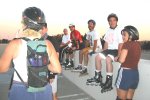 Skaters - Barbara, Guy, Trevor, Steve, Critter, Mitchell, Yvonne - rest atop Sac State Parking Lot on the August 5, 2002 Monday Night Skate.